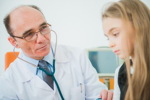 Pediatric Podiatry Care. Children Pediatric Doctor Checking on Sick Caucasian Girl.