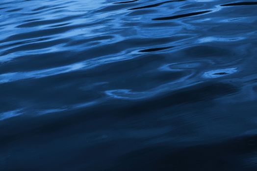 Deep Blue Ocean Surface Nature Photo Background. Dark Blue Wavy Water.