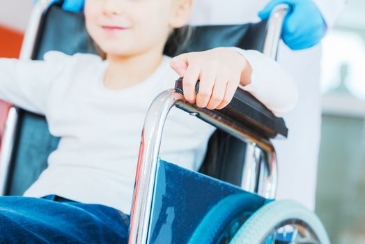 Disabled Caucasian Girl on the Wheelchair. Closeup Photo. Healthcare Photo Concept.