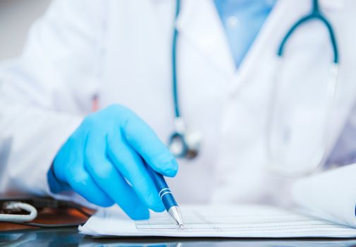 Doctor Documentation Check. Medical Doctor Working in His Hospital Room Checking Important Sickness History Documents Looking For Cure Solution. Doctor Looking For Cure Solution