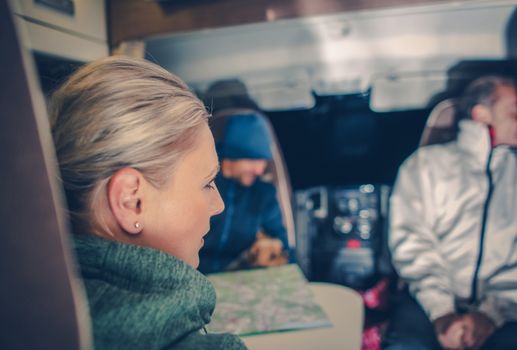 Family in the Camper Van. Family RV Trip. Focus on the Caucasian Woman Seating Inside.Camping and Rving Theme.