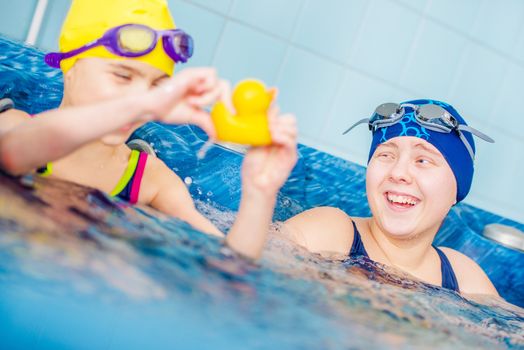 Happy Children in the Jacuzzi. Two Caucasian Girls Having Fun in the the Jacuzzi. Children Recreation Concept.