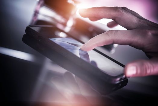 Smartphone Mobile Device. Surfing the Internet on Smartphone. Female Hand Touching the Screen.