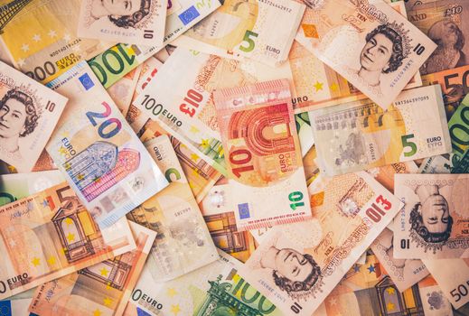 European Currencies Background. Colorful European Cash Money Banknotes. British Pounds and Euros Closeup Photo Backdrop.