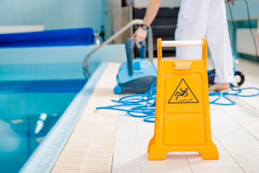Swimming Pool Cleaning Time. Watch For Slippery Tile Floor Yellow Warning Sign. 