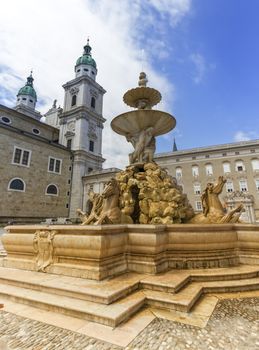 Fountain and cathedral at the Residenzplatz in Salzburg by day, Austria