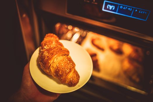 Baking Tasteful Croissants. Fresh Croissant Breakfast.