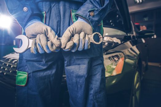 Car Mechanic Ready For Work. Auto Mechanic with Large Wrench in Hands. 