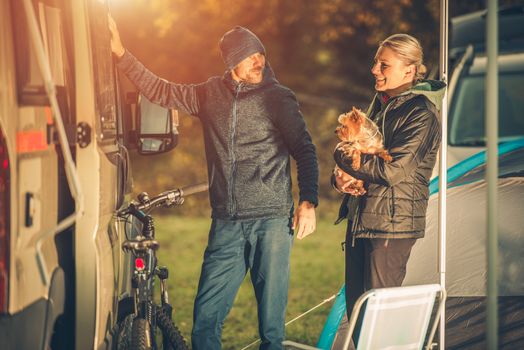 Young Caucasian Couples with Dog Motorhome RV Camping. Campground Fun.