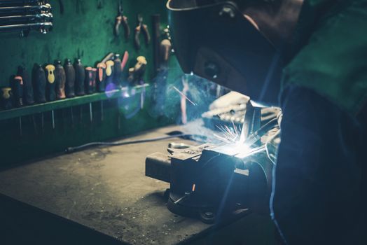 Welder Fusing Metal Together. Welding Metal Parts in the Small Workshop.
