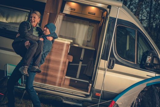 Happy Couples and the RV. Young Couples on the Campground with Their Motorhome Enjoying New Purchase.