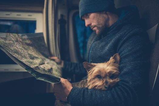 Men and His Dog Friend. Australian Silky Terrier York Relaxing on the Traveling Men Legs. Traveling Pet in the Class B RV Motorhome Camper. 