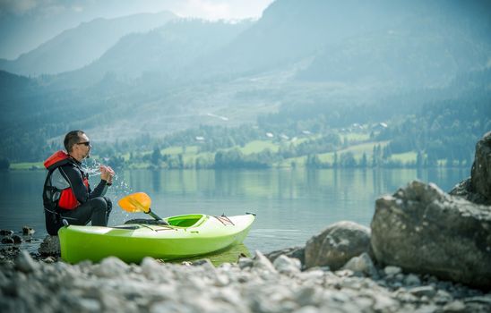 Recreational Lake Kayaking. Young Caucasian Sportsman at the Lake with His Kayak.