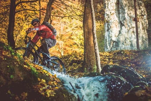 Scenic Forest Bike Trail. Fall Foliage Biking. Caucasian Men on the Bike Trip.