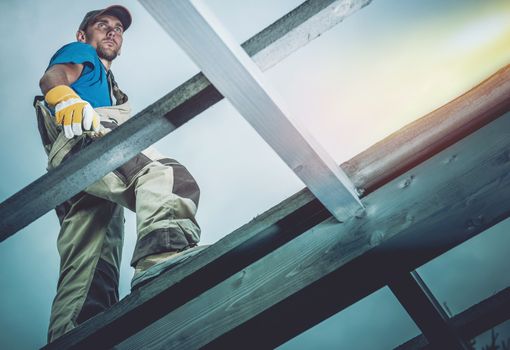 Carpenter on Wooden Frame. Construction Worker and His Wood Job.