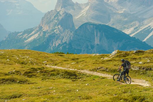Mountain Biking Adventures. Men on the Bike on the Mountain Trail. Italian Dolomites.