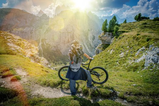 Mountain Trail Biking. Scenic Place in the Mountains. Caucasian Biker Taking Moment to Enjoy the View. Italian Dolomites.