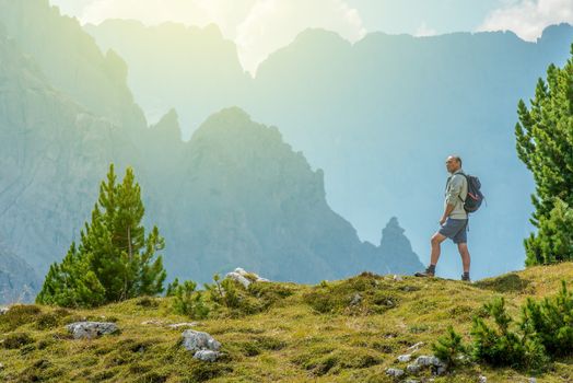 Senior Hiker with Backpack and the Scenic Mountain Vista. Italian Dolomites.