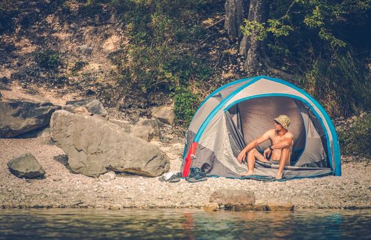 Tent Camping on the Rocky Lake Shore. Outdoor Men Lifestyle. 