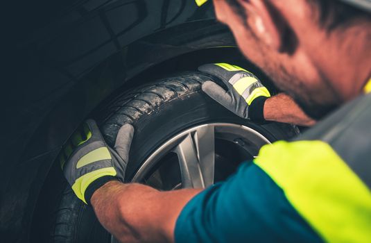 Tire and Wheel Service. Men Preparing Equipment For a Tire Service.