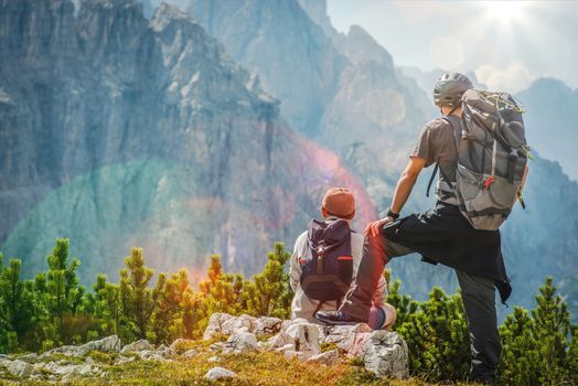 Hiker and Biker on a Trail Enjoying Amazing Mountain Vista.