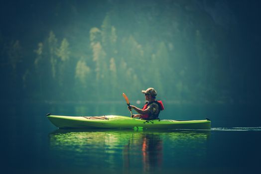 Kayak Tour on the Lake. Middle Age Caucasian Men in the Kayak on the Scenic Lake.