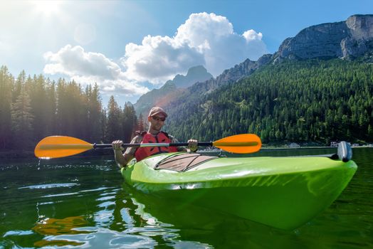 Caucasian Sportsman Kayaking on the Scenic Lake. Italian Dolomites, Lake Misurina, Europe.