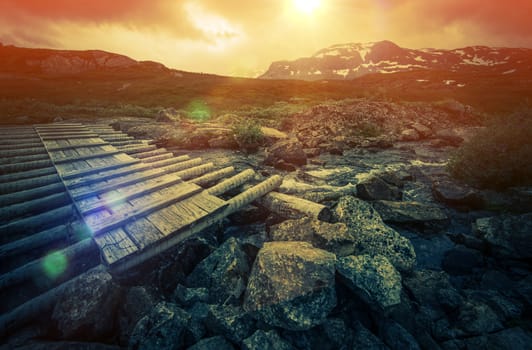Wooden Trail Bridge and the Norwegian Mountain Landscape. Norway, Europe.