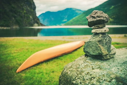 Destination Norway Cairn. Norwegian Fjord, Kayak and Pile of Stones Left by Tourist.
