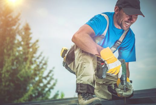 Happy Construction Worker Smiling While Working on Wooden Roof. Satisfied Worker.