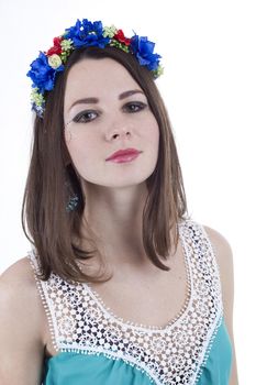 Studio portrait of a young beautiful woman with flower wreath on head.