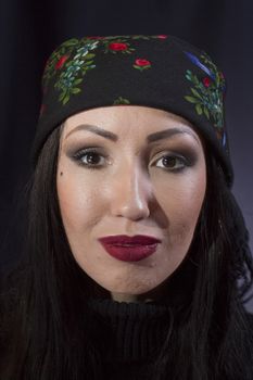 Portrait of a young gypsy woman on a black background