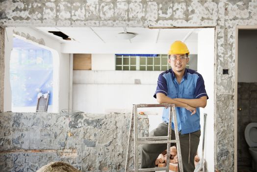 House renewal concept. Asian construction worker smiling and looking at camera.