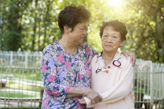 Candid shot of Asian elderly women at outdoor park in the morning.