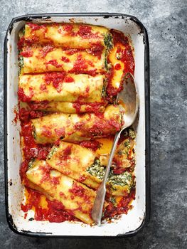 close up of rustic italian spinach ricotta cannelloni pasta