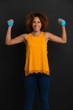 Beautiful African American woman lifting weights