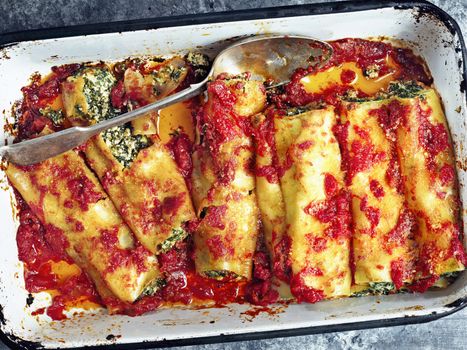 close up of rustic italian spinach ricotta cannelloni pasta