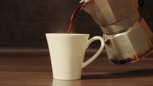 Coffee pouring into a cup close up