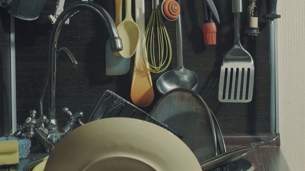 Kitchen utensils and water tap, close up