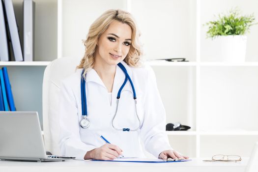 Portrait of smiling beautiful female doctor in a clinical office