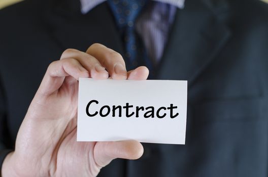 Contract text note concept over business man background