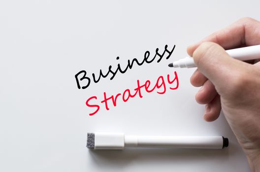 Human hand writing business strategy on whiteboard