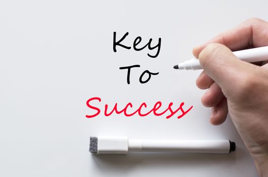 Human hand writing key to success on whiteboard