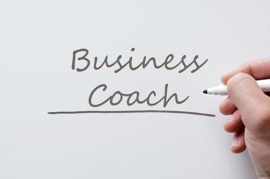 Human hand writing business coach on whiteboard