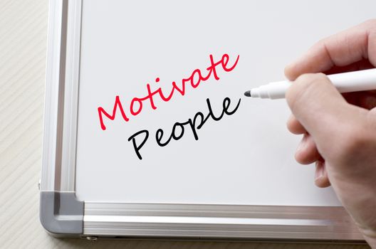 Human hand writing motivate people on whiteboard