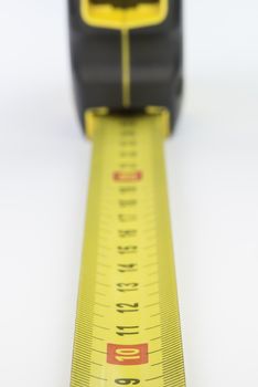 Yellow metal industrial tape measure with standardized metric system such as used in Europe.
