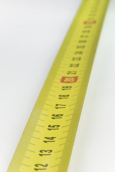 Yellow metal industrial tape measure with standardized metric system such as used in Europe.
