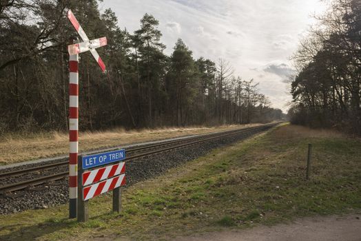 Unguarded, light rail railway crossing without barriers and warning lights in the East of the Netherlands
