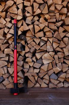 Big axe over stacked firewood background
