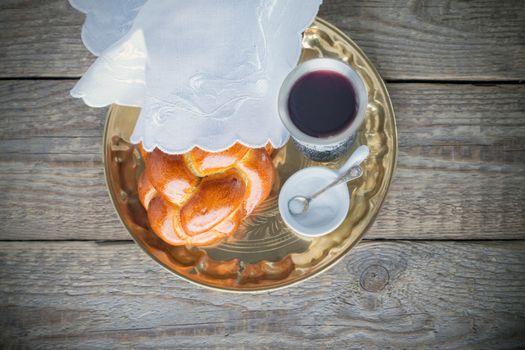 Wine, challah on a wooden surface. Jewish Sabbath